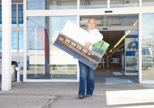 Woman carrying TV out of store